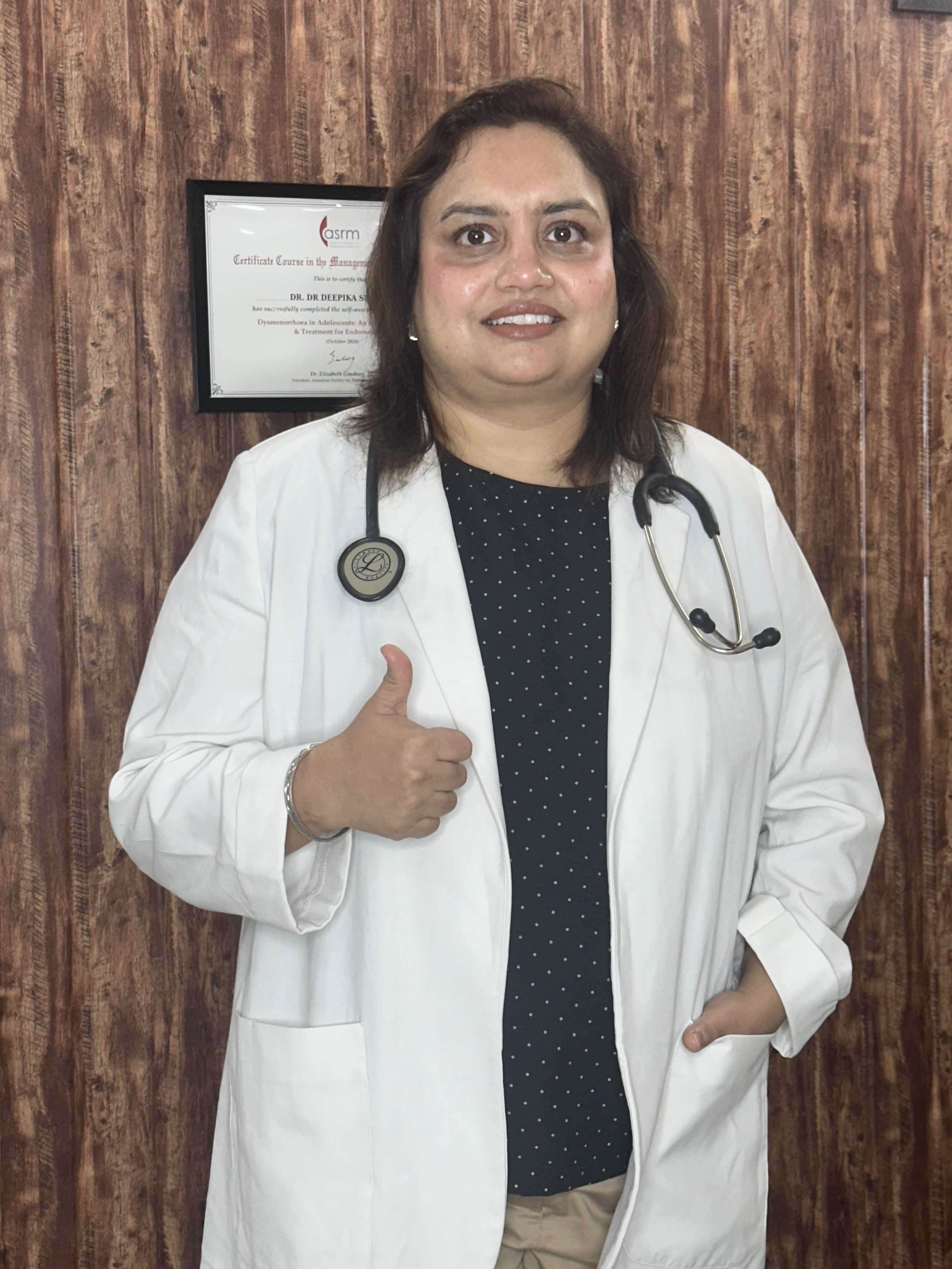 Dr. Deepika Singh in her clinic with certification